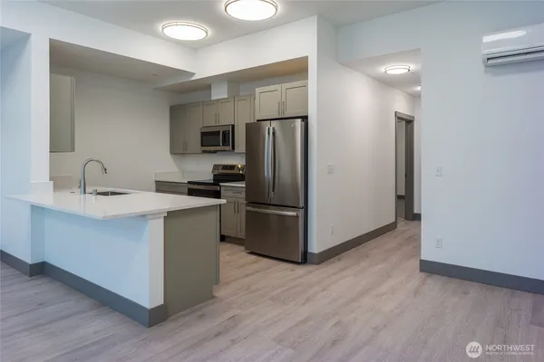 a kitchen with a refrigerator sink and an oven