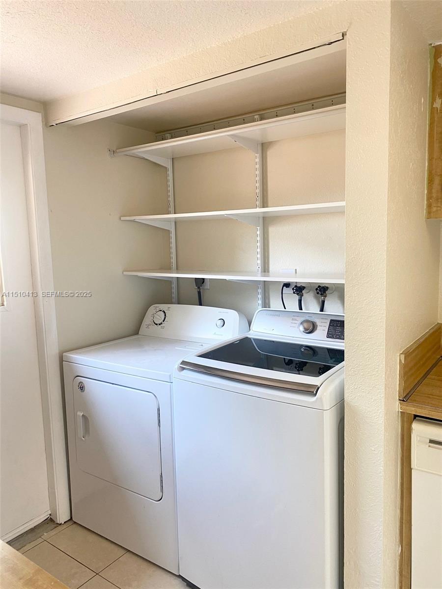 7351 West Sunrise Boulevard, Unit 7351 Plantation, FL 33322 - Photo 17 of 44 a utility room with dryer and washer