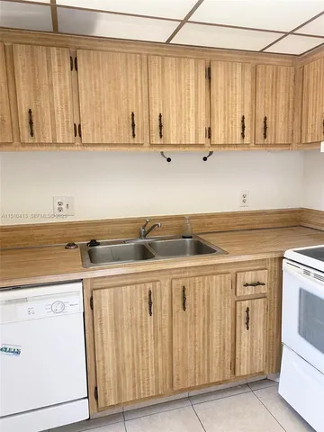 a kitchen with a stove cabinets and a sink