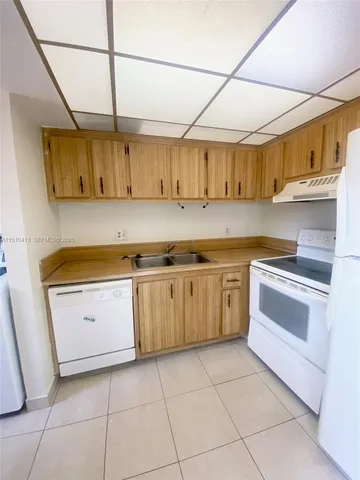 a utility room with cabinets washer and dryer