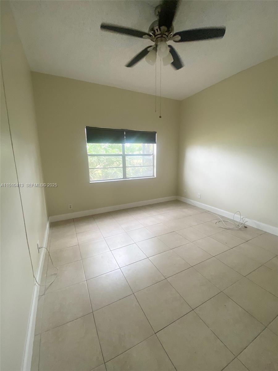 7351 West Sunrise Boulevard, Unit 7351 Plantation, FL 33322 - Photo 24 of 44 a view of an empty room with a window
