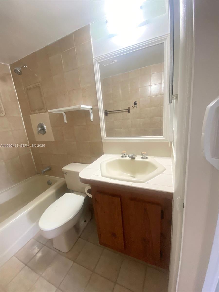 7351 West Sunrise Boulevard, Unit 7351 Plantation, FL 33322 - Photo 27 of 44 a bathroom with a sink toilet and shower