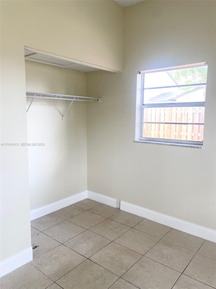 7351 West Sunrise Boulevard, Unit 7351 Plantation, FL 33322 - Photo 29 of 44 a view of a room with rack on the wall and a window