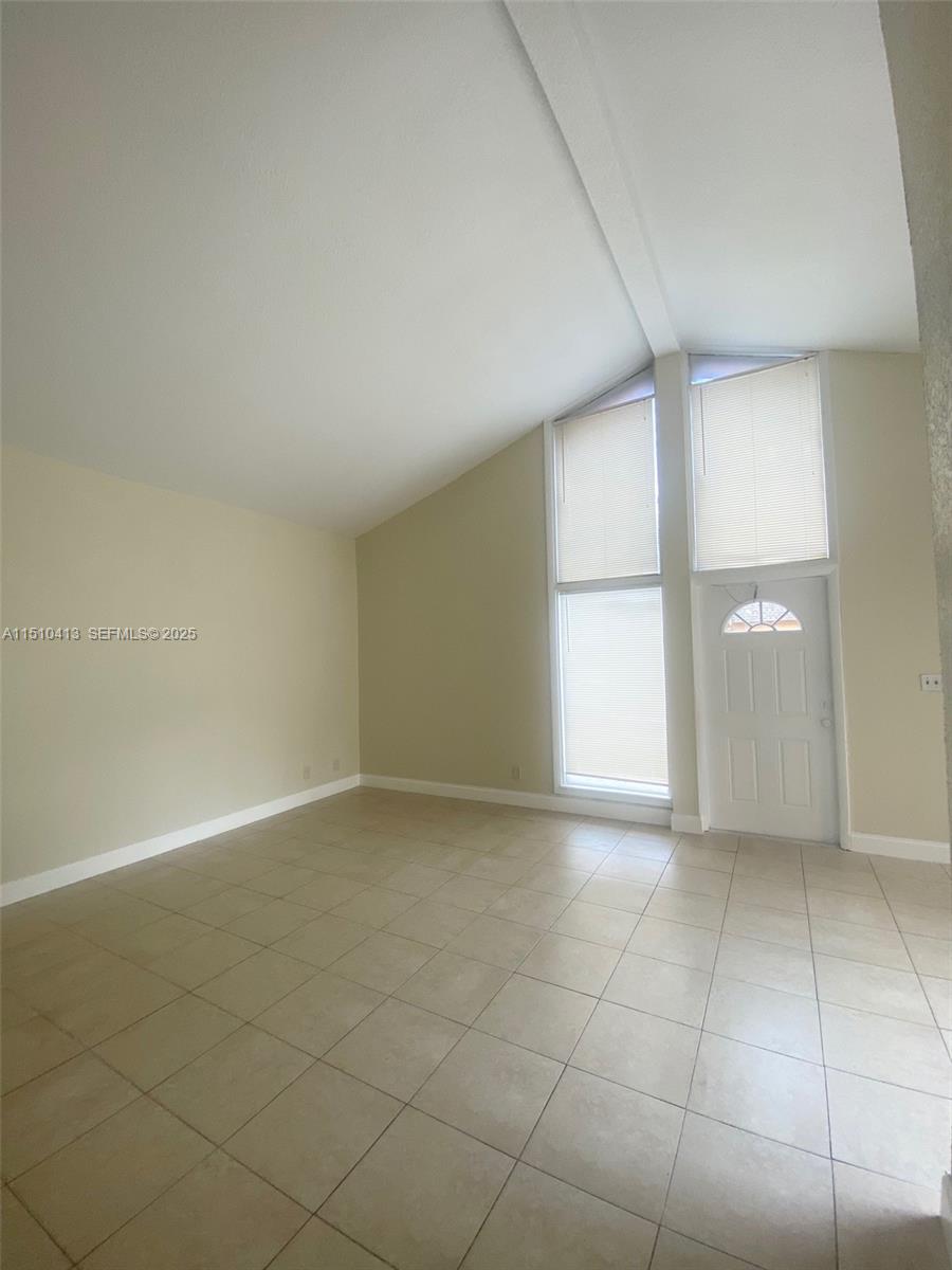 7351 West Sunrise Boulevard, Unit 7351 Plantation, FL 33322 - Photo 3 of 44 an empty room with a empty space and windows