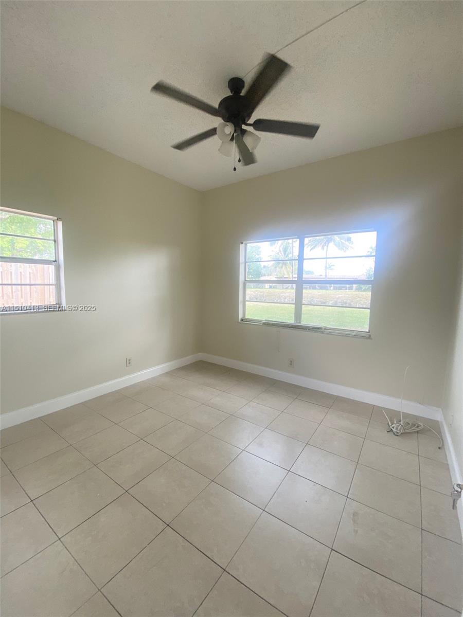 7351 West Sunrise Boulevard, Unit 7351 Plantation, FL 33322 - Photo 31 of 44 a view of an empty room with a window