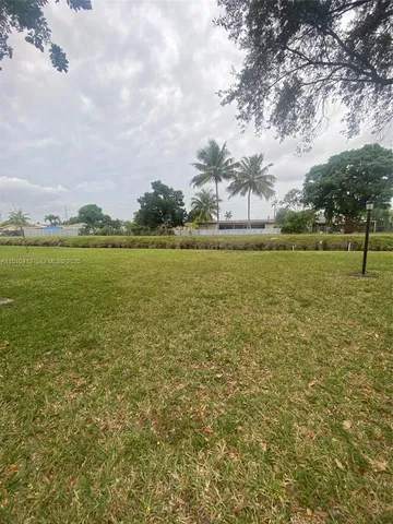 a view of a backyard with large trees