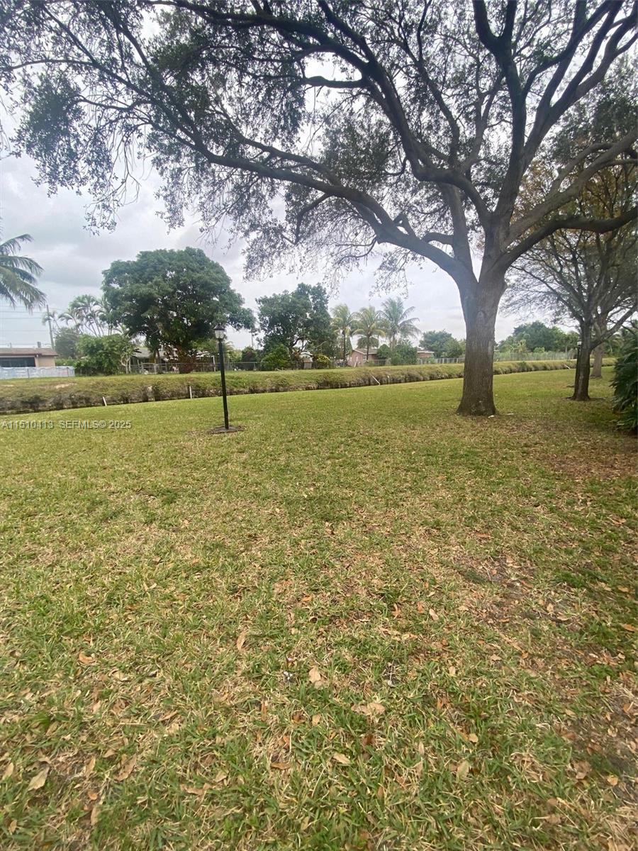 7351 West Sunrise Boulevard, Unit 7351 Plantation, FL 33322 - Photo 40 of 44 a view of outdoor space with trees all around