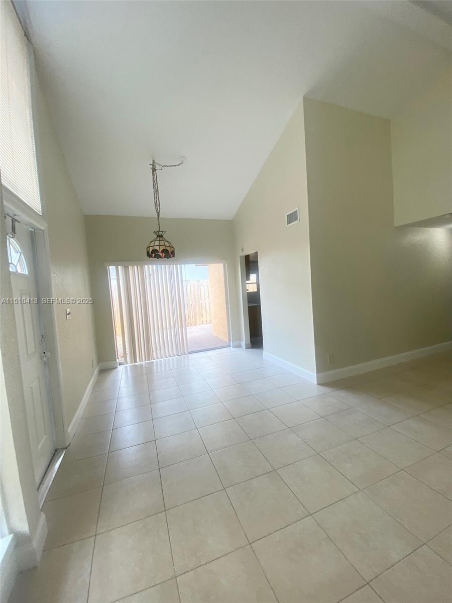 7351 West Sunrise Boulevard, Unit 7351 Plantation, FL 33322 - Photo 7 of 44 a view of a hallway with a chandelier