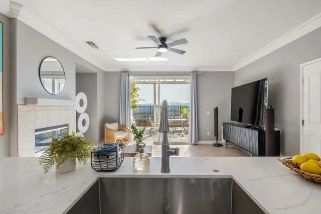a living room with fireplace furniture and a large window