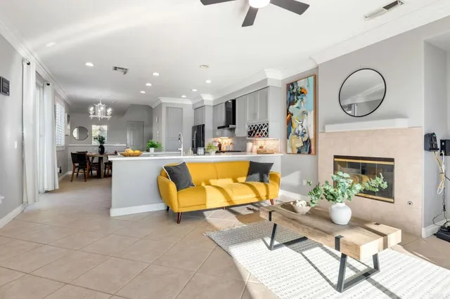 a living room with furniture kitchen view and a fireplace