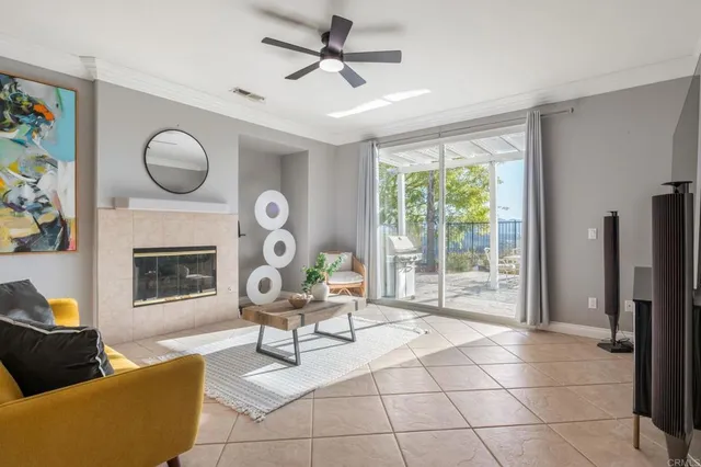 a living room with furniture a fireplace and a floor to ceiling window