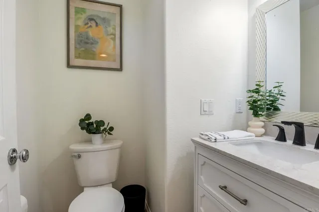 a bathroom with a toilet a sink and mirror