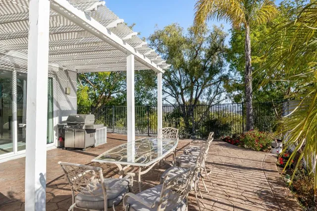 a view of a patio with table and chairs and potted plants