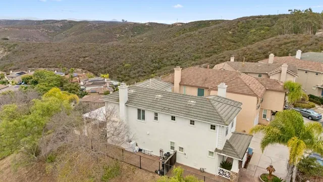 an aerial view of a house with a mountain