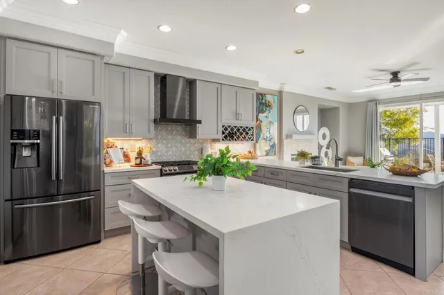 a kitchen with stainless steel appliances a sink and a refrigerator