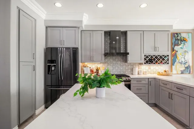 a kitchen with stainless steel appliances a refrigerator and a sink