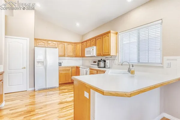 a view of a kitchen cabinets and wooden floor