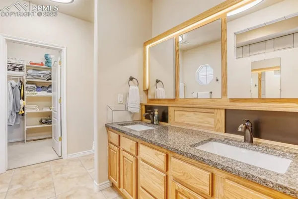 a bathroom with a double vanity sink a mirror and a shower