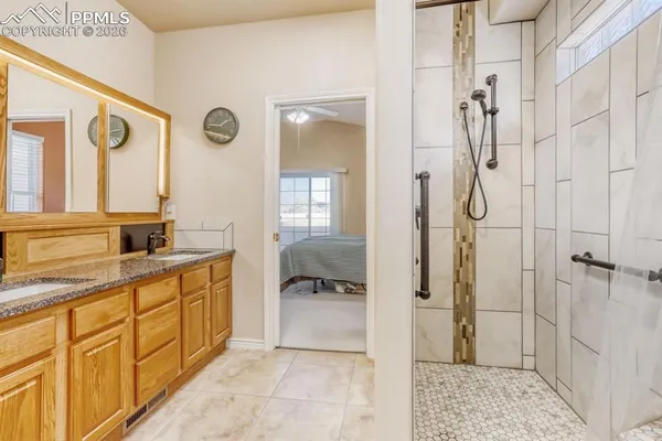 a bathroom with a granite countertop sink toilet and shower