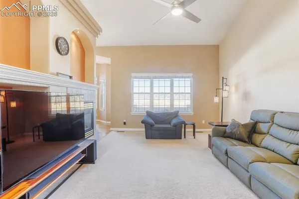 a living room with furniture and a fireplace