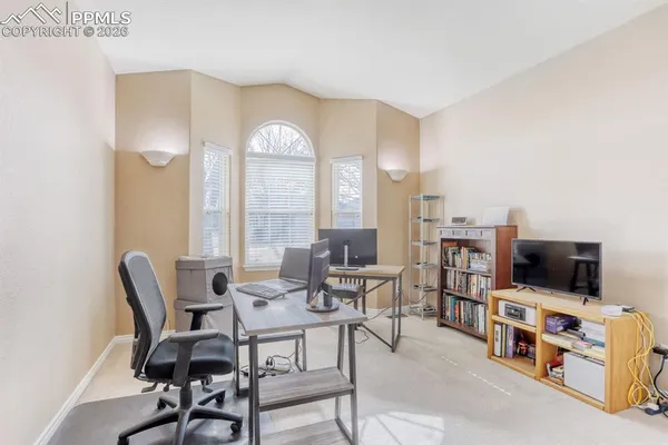 a view of a workspace with furniture and a flat screen tv
