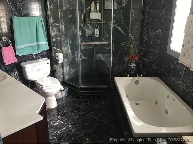 a white toilet sitting next to a white toilet and sink