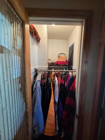 a kitchen with a refrigerator and a stove top oven