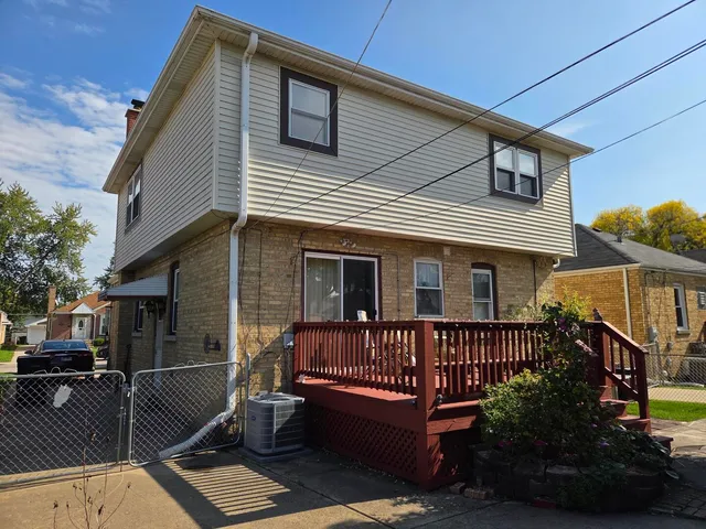 a view of a house with wooden deck