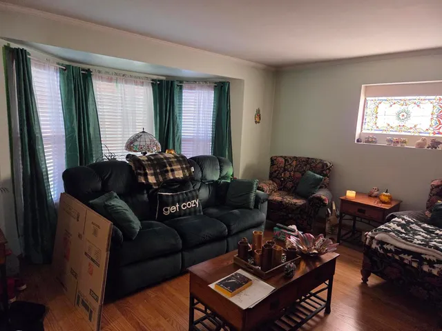 a living room with furniture a rug and a flat screen tv