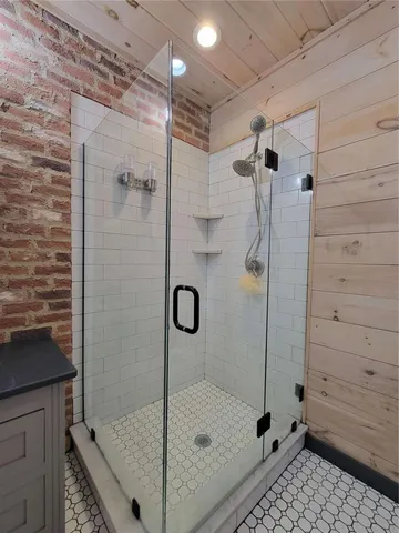 a bathroom with a shower and a sink