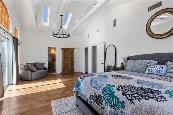 a bedroom with bed and a chandelier