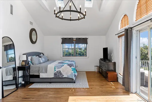 a bedroom with bed and glass windows