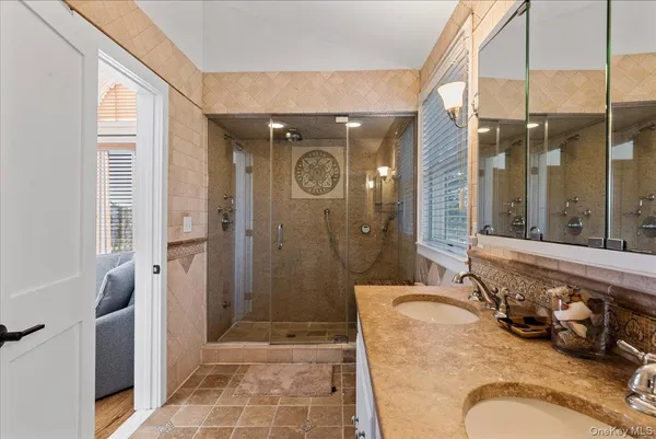 a bathroom with a granite countertop tub sink and shower