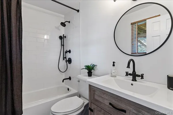 a bathroom with a sink a toilet and a mirror