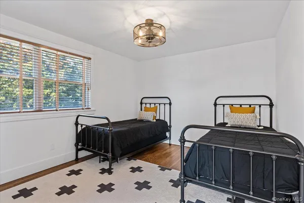 a living room with a bed furniture and a window