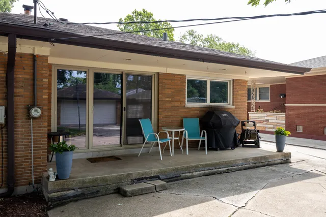 a backyard of a house with yard fire pit and chairs