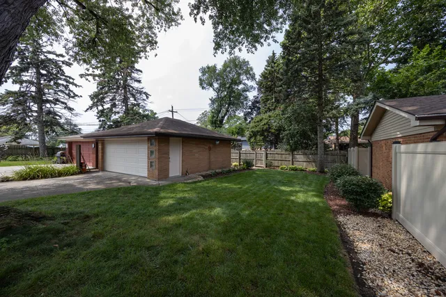 a view of backyard of house with green space