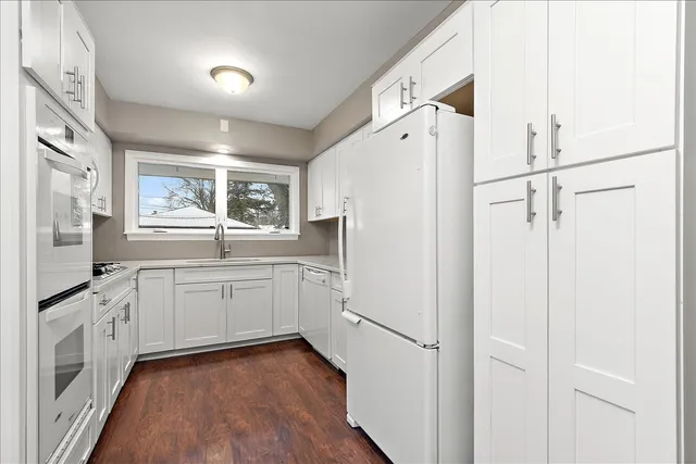 a kitchen with granite countertop cabinets appliances and a counter top space