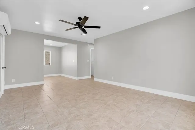 a view of a livingroom with a ceiling fan and window