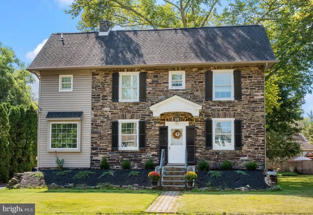 a front view of a house with yard and garage