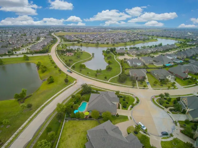 an aerial view of a house with yard swimming pool and outdoor seating