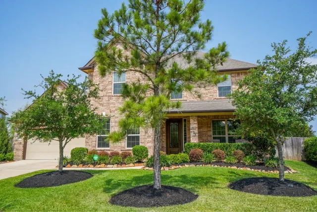 a view of an empty room with a window and fireplace