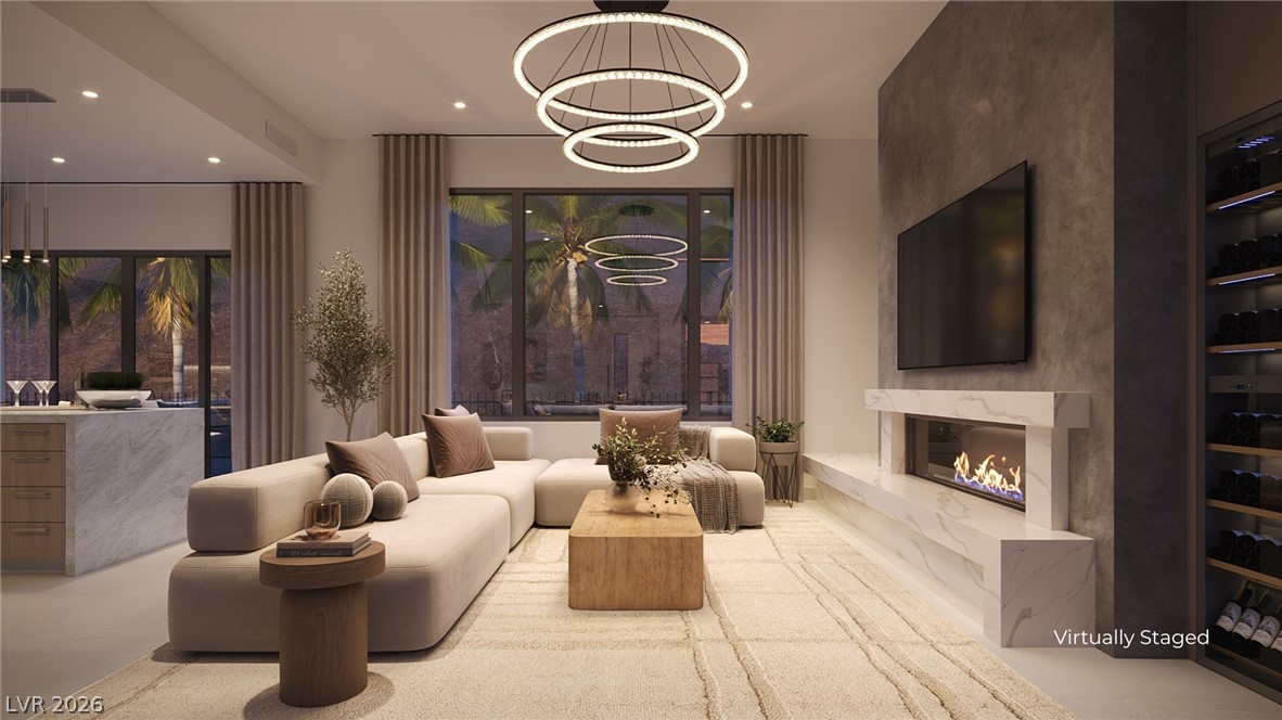 505 Overlook Rim Drive Henderson, NV 89012 - Photo 6 of 22 Sleek, open-concept living area boasts high ceilings and recessed lighting, offering ample space for comfortable entertaining.