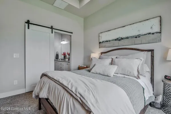 a bedroom with a bed and a mirror