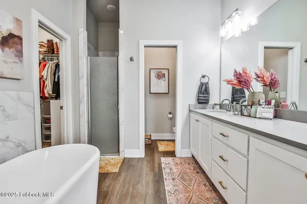 a bathroom with a tub sink and mirror