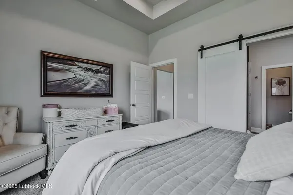 a bedroom with a bed and a couch