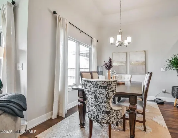 a view of a dining room with furniture and chandelier