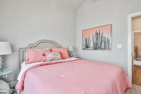 a bedroom with a bed and a painting on the wall