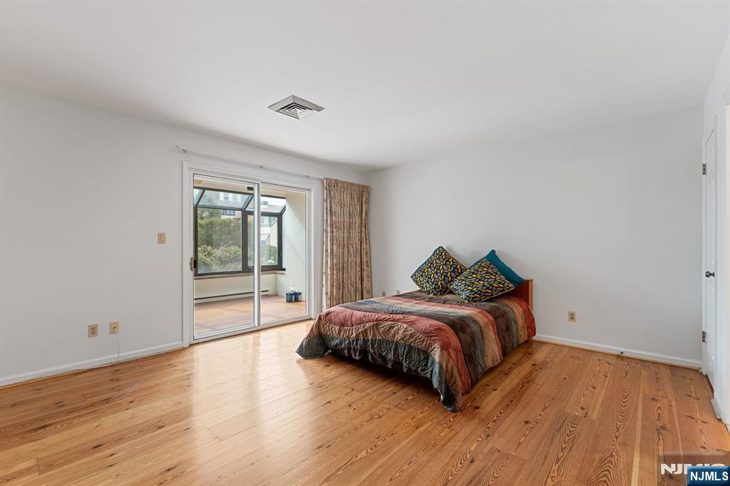 300 Gorge Road, Unit 25 Cliffside Park, NJ 07010 - Photo 22 of 45 a room with a bed and wooden floor
