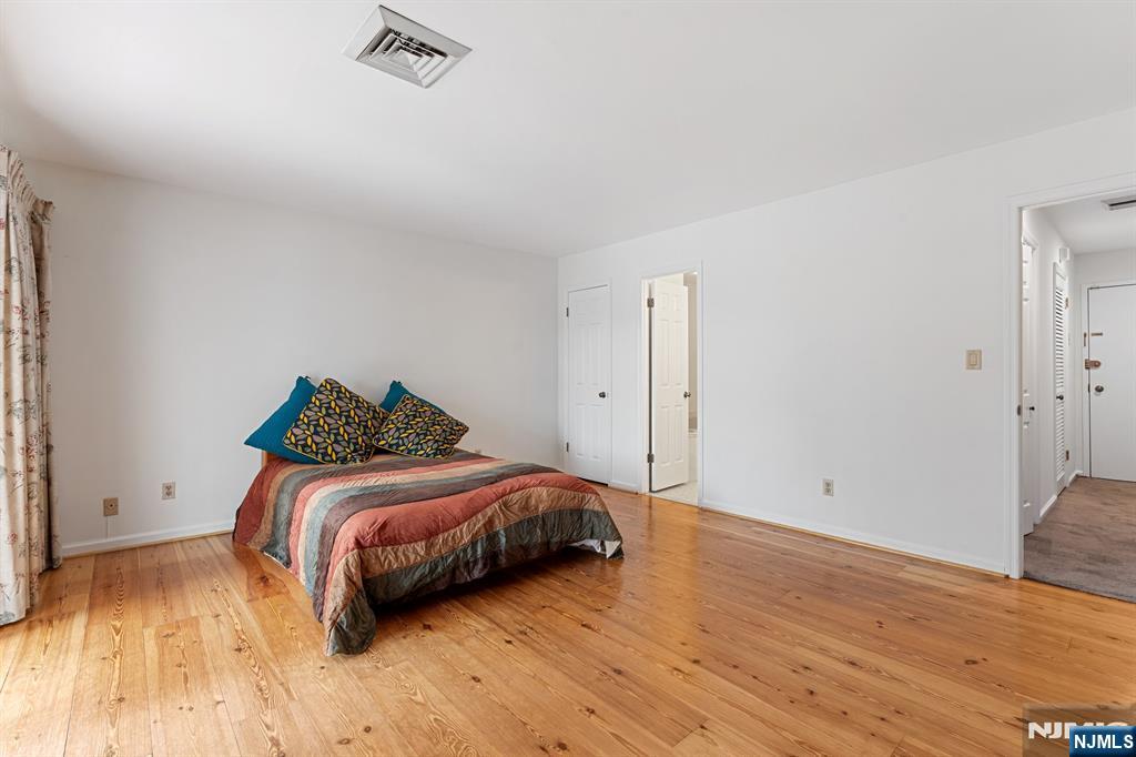 300 Gorge Road, Unit 25 Cliffside Park, NJ 07010 - Photo 24 of 45 a bedroom with a bed and a wooden floor